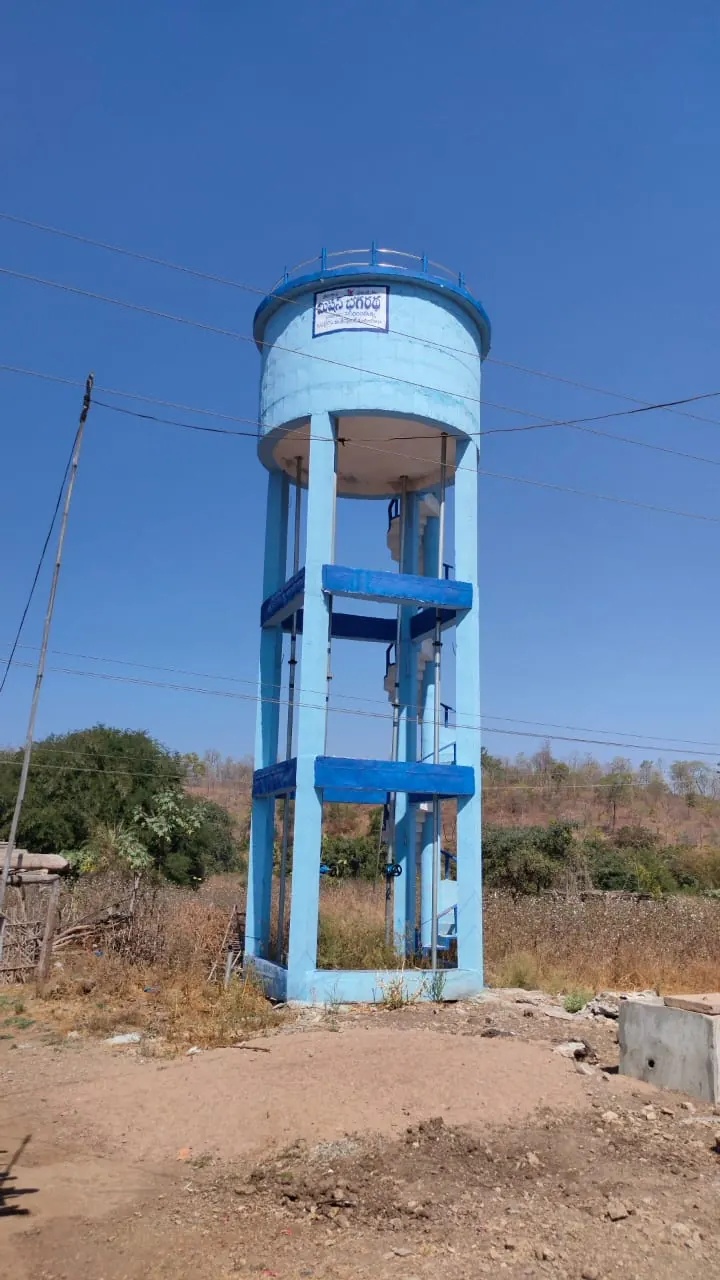 Overhead water tank with a Mission Bhagiratha signboard