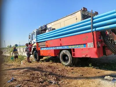 Red truck-mounted drilling rig TS 08 GV 2616 loaded with blue casing pipes