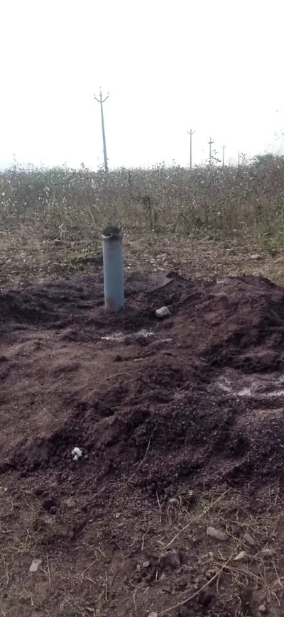 Borewell casing pipe rising from freshly drilled ground